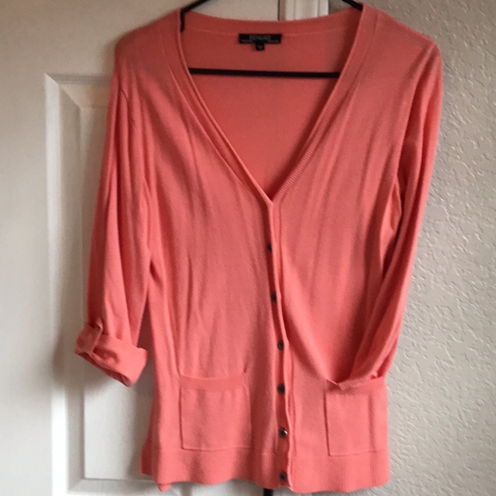 Coral colored light knit cardigan.
